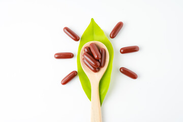 Vitamin capsules in a wooden spoon, soft gels, Fish oil capsules, omega 3, omega 9, vitamin D, vitamin E