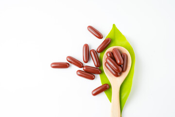 Vitamin capsules in a wooden spoon, soft gels, Fish oil capsules, omega 3, omega 9, vitamin D,...