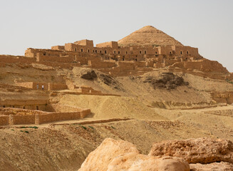 The dilapidated ruins of the ancient abandoned village of Ksar Hermes, standing on a hilltop in...