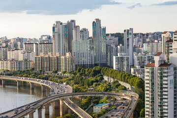 Mapo-gu, Seoul, South Korea - September 26, 2018: Summer view of cars driving on Gangbyeon Expressway near Han River with high rise apartments
