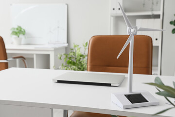Wind turbine model on desk in engineer's office, closeup