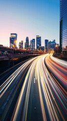 Fototapeta premium Long exposure of city traffic at dusk with skyscrapers and office buildings in the background.