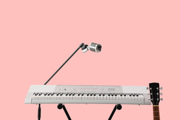 Modern synthesizer, guitar and microphone on pink background
