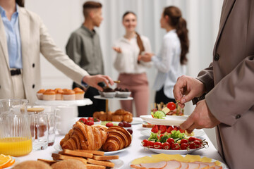Coworkers having business lunch in restaurant, closeup