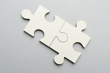 Fototapeta premium White puzzle pieces on grey background, top view