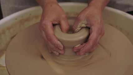 Creating a ceramic bowl by yourself in a pottery class 4k video. Wheel throwing. Learning how to model clay into different shapes with pottery wheel.