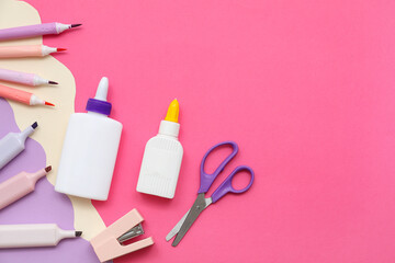 Bottles of glue, markers and felt-tip pens on pink background. Top view