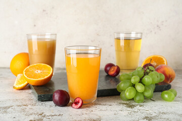 Glasses of fresh juice with different fruits on white background