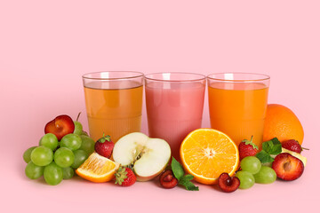 Glasses of fresh juice with different fruits and mint on pink background