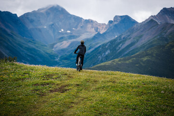 Riding mountain bike on grassland mountain top