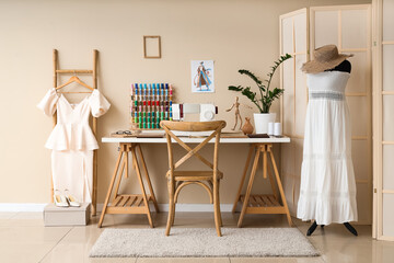 Interior of atelier with tailor's workplace, mannequin and folding screen