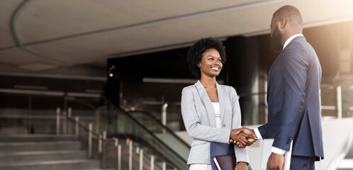 Nice to meet you. Two young african american business people introducing outdoors, copy space