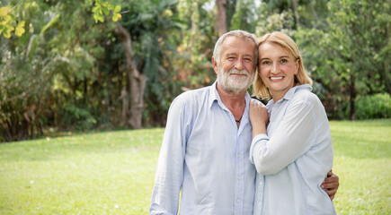 Happy old elderly caucasian couple smiling in park on sunny day, hoot senior couple relax in spring summer time. Healthcare lifestyle elderly retirement love couple together valentines day concept