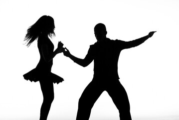 Silhouettes of characters, musicians and dancers on backlighting.