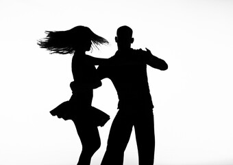 Silhouettes of characters, musicians and dancers on backlighting.
