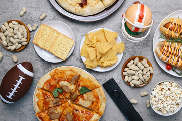 Flay Lay Of Various Fast Foods With Sport Equipments Over Grey Background. Watching Sports Match
