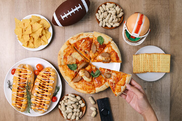 Hands Taking Piece Of Pizza. Various Fast Foods And Sport Equipments On The Table