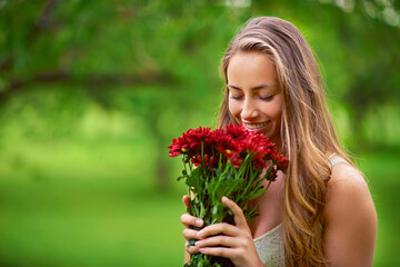 Nature, woman and happy for smelling flowers, summer time and eco friendly gift with mockup. Female person, smile and chrysanthemum bouquet with space for scent, floral present and ecology in park