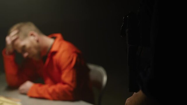 Gun on police holster and inmate being interrogated