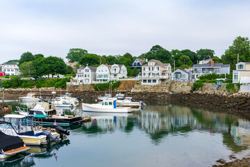 A view of Rockport Harbor with boats and costal houses, Massachusetts, USA