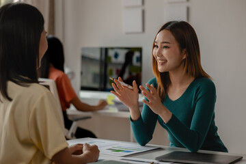 one of entrepreneur team is explaining an important strategy to achieve their goal, partners have a comfy meeting about new project, teamwork is the key to success