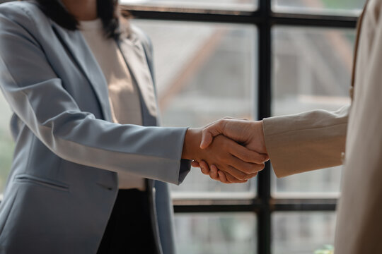 two big companies handshake because they agree on a business deal, businesspeople just signed commitment contract for merge and expand their business for they will get more customer base than normally