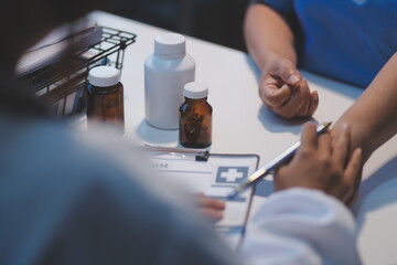 Doctor giving hope. Close up shot of young female physician leaning forward to smiling elderly lady patient holding her hand in palms. Woman caretaker in white coat supporting encouraging old person