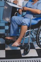 Obraz premium Asian young professional successful friendly female nurse in blue hospital uniform helping supporting physical therapy senior old pensioner unhealthy injury woman patient walking via four legs walker.