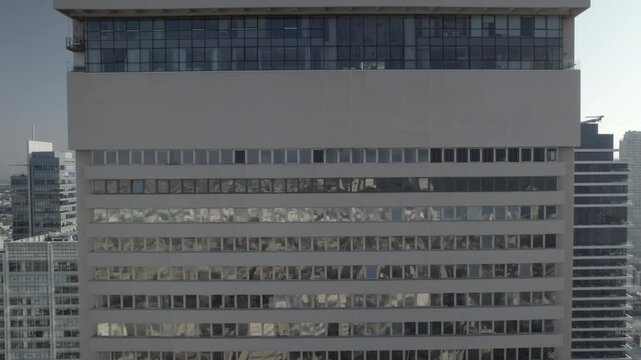 Pull back in drone shot from Shalom Meir Tower, tel aviv and the city towers on rothschild street in the background (D-log)