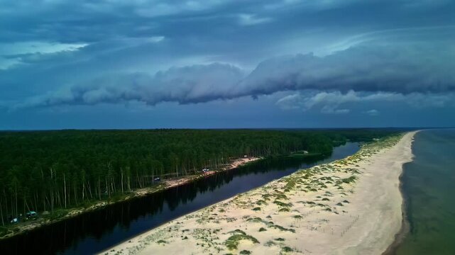 Aerial orbit Dunes at the mouth of the Irbe River in Latvia with thunder clouds