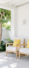 A white house with a porch and two yellow chairs
