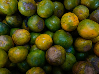 Stacks of orange fruits that look very fresh with a tasteful color at market outdoor