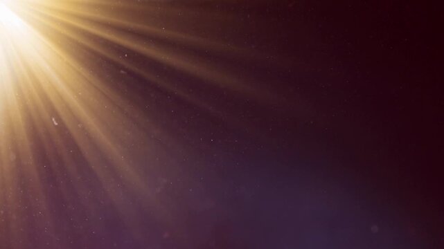 Loop of rays glow orange gold optical flare shine light from the top left animation on black abstract background for screen project overlay. Side diagonal light optical lens flares shiny animation Fla