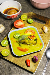 Ikan patin kuah kuning or catfish cooked in yellow sauce. Indonesian dishes have a savory and spicy taste