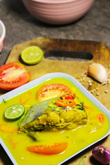 Ikan patin kuah kuning or catfish cooked in yellow sauce. Indonesian dishes have a savory and spicy taste