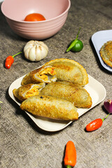 Cireng filled with spicy shredded chicken cut in the middle. It looks full of filling inside