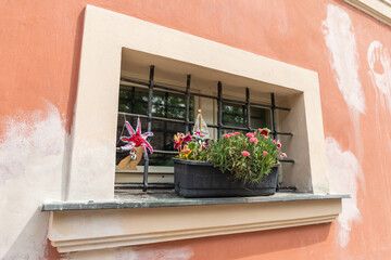 Decorative  decorations and flower pot on the windowsill of a building in Visegrad district in Prague in Czech Republic