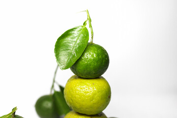 Stacked kaffir limes on a white background