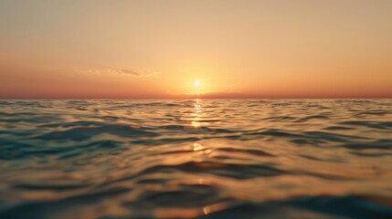 Sunset over the ocean with gentle waves and colorful reflections.