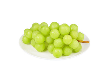 A bunch of fresh Shine Muscat on a white plate. white background - vitis vinifera 'shine muscat'