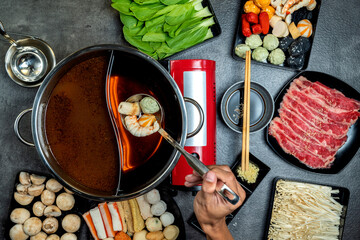 A person is eating food from a bowl with chopsticks