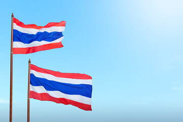 A red, white, and blue Thailand flag is flying