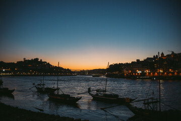 Naklejka premium Porto, Portugal, Oporto on the Duoro River at night, sunset, light on the water front, bridge, Ponte Luiz, Eiffel bridge, tourism, travel, Europe tourist destination