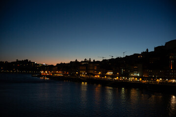 Naklejka premium Porto, Portugal, Oporto on the Duoro River at night, sunset, light on the water front, bridge, Ponte Luiz, Eiffel bridge, tourism, travel, Europe tourist destination