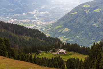 Alpine hut Hochganghaus and mountain panorama with city Merano in Texel group, South Tyrol, Italy