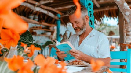Middle-Aged White Man Dining Alone, Relaxing and Reading Book in Cozy, Naturally Lit Restaurant During the Daytime