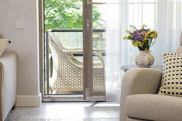 Sliding door in living room with exit to terrace. Modern furniture in Scandinavian style. Interior and design. 