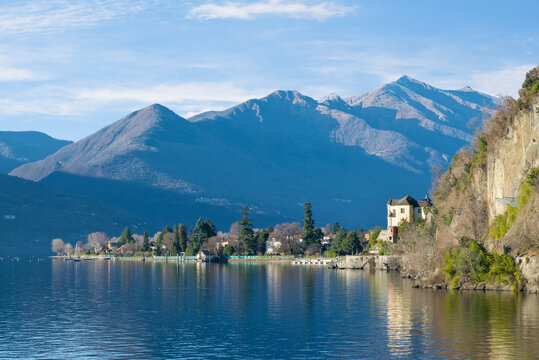 Lake Maggiore with the lakeside of the town of Maccagno, Italy. To the right the Madonna della Punta sanctuary