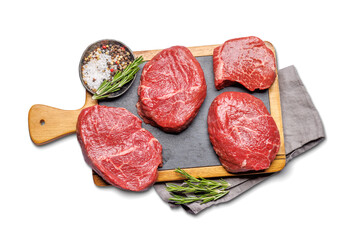 Raw beef fillet steaks on a cutting board, fresh and uncooked