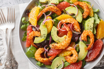 Citrus Shrimp and Avocado Salad closeup on the plate on the table. Horizontal top view from above